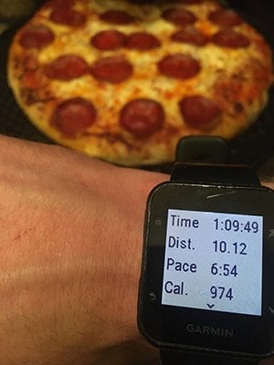 Pizza and watch showing running stats