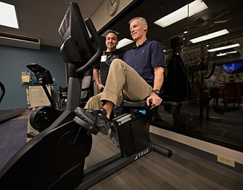 John Roche works with a Genesis Cardiac team member.